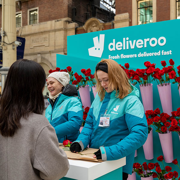 Commuters interacting with Deliveroo activation
